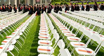 Image of commencement chairs on the campus green.